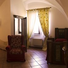 Superior room, sleeping beneath the quiet elegance of ancient stone vault Superior room in a historic Apulian masseria with vaulted ceiling and traditional details