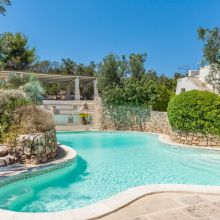 Outdoor swimming pool and landscaped grounds at a Salento holiday retreat