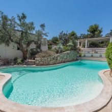 Swimming pool surrounded by Mediterranean greenery at holiday apartments in Salento