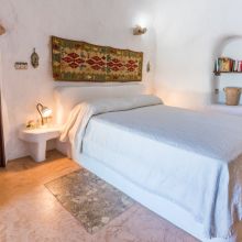 Country-style bedroom with traditional furnishings in an Apulian holiday home near Ugento