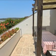 The terrace of a sea view of an apartment, the sea, always within sight Outdoor dining area on a furnished terrace at a self-catering apartment in Salento, Apulia