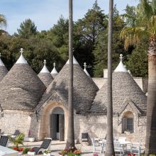 Trulli merged in the green of the olive groves in Puglia B&B Valle dei Trulli, view of the trulli