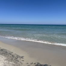 Sandy beach with turquoise sea and crystal-clear waters along the Salento coast in Puglia, southern Italy