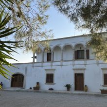 A place where the stones remember generations of country life Historic Apulian masseria with traditional stone facade in the Puglian countryside