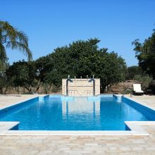 A little Mediterranean blue, all to yourself Blue swimming pool reflecting the sky at a countryside resort in Puglia