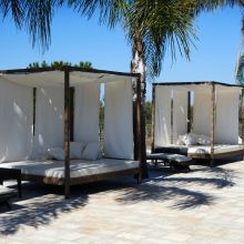 A cool corner for the hottest hours of the day Shaded relaxation area beside the swimming pool at an Apulian country estate