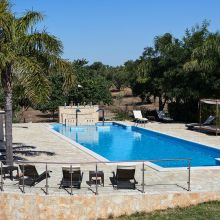 A cool blue pause beneath the southern Italian sun Swimming pool at an Apulian countryside farmhouse surrounded by greenery
