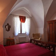 Superior room, beneath a ceiling shaped by the hands of old master builders Apulian masseria superior bedroom with a traditional star-vaulted ceiling