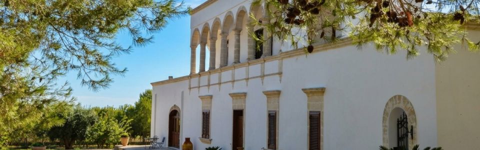 Where the timeless beauty of the Apulian countryside unfolds Traditional Apulian masseria surrounded by vineyards and Mediterranean countryside