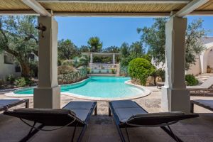 Where Summer Days Drift by Slowly Swimming pool surrounded by Mediterranean greenery at holiday apartments in Salento, Puglia